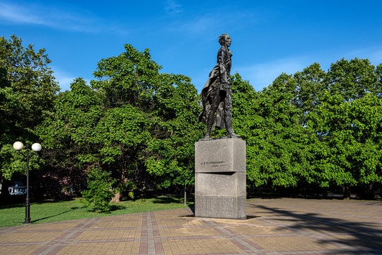 Russia, Black Sea, Sochi: Nikolai Ostrovsky statue monument in a public park in the city center of the Russian town with square, green trees, garden and blue blue sky - literature author culture