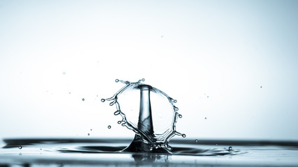 Close-up of a water drop falling on water surface