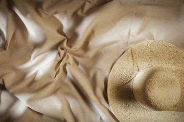 Flat light brown beige linen cotton fabric background seen from above with copy space for advertising products.