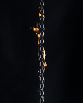 Iron Chain On Fire On A Black Background