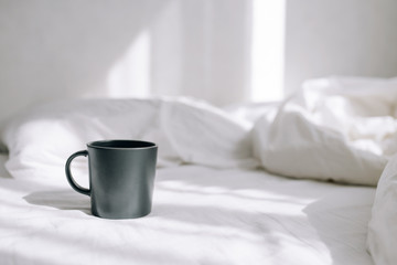 Cup of coffee on a bed