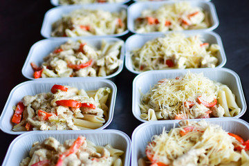 Food delivery. preparing food portions in containers. delivery service during quarantine covid-19. Chicken with vegetables and cheese. airline food. airline meals and snacks. takeaway selective focus