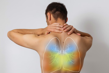 Human lungs, man holding his hand in the area of their lungs.