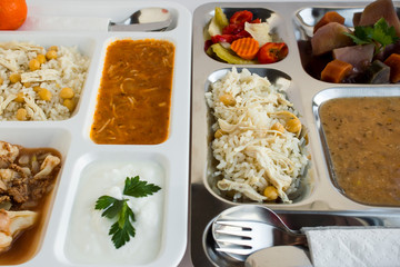 Traditional Turkish rice, cooked with chickpeas and chicken, vermicelli soup, yogurt and colorful pickles on portion trays (table d'hote)