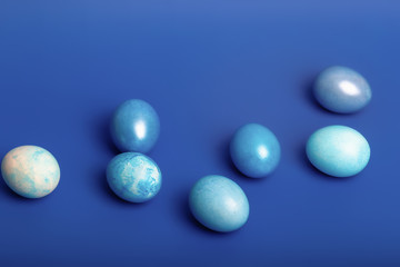 Easter still life with blue eggs on a blue background.