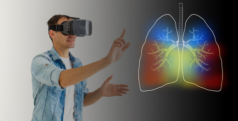a man in virtual 3 d glasses looks at the lungs, coronavirus, pneumonia