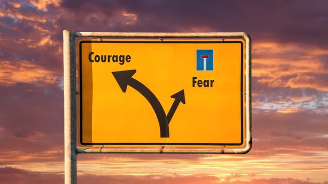 Street Sign the Way to Courage versus Fear