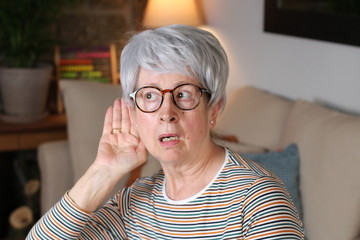 Shocked senior woman at home 