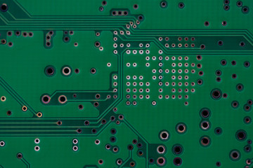 Close-up of an electronic circuit board. Empty board with holes for components, not populated