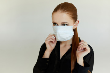 Young woman with respiration medical mask with the face mask on to prevent disease spreading...