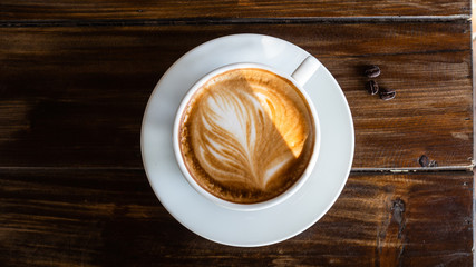 Black coffee bean, white round shape coffee cup on old wooden table top view. lifestyle concept