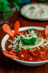 Butter Chicken served in a white bowl