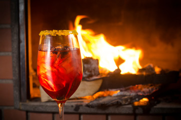 glass of red cocktail on fire