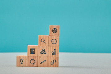 Business strategy and growth. Efficiency and forecasting. Career ladder. Pyramid of wooden cubes with management signs
