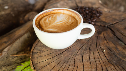Black coffee cup on old wooden table top view. note book and pencil. lifestyle concept