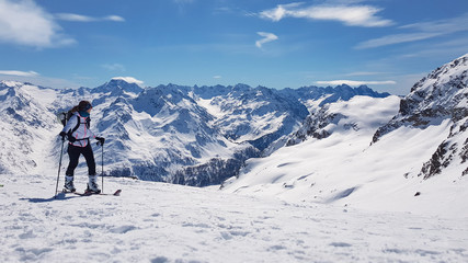 Fototapeta na wymiar skitouring girl in the mountains, Piz Lagrev Schweiz