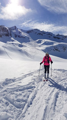 Fototapeta na wymiar girl running down the mountain on skis