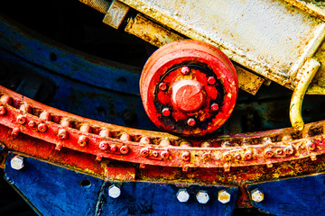 Grunge rotor wheel and a guiding track of a vintage rotary shovel. Industrial abstract art. Yellow,...
