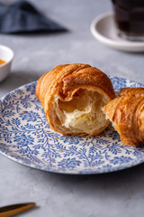 Fresh croissant and black coffee for breakfast