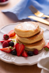 Trendy Japanese fluffy pancakes for breakfast with berries