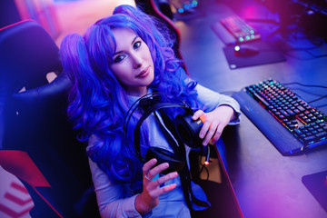 Young woman professional gamer playing winning tournaments online games computer