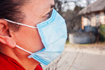 Woman wearing black sunglasses atex gloves and medical face mask