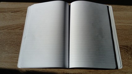 U-turn notebook with blank white pages. Natural light