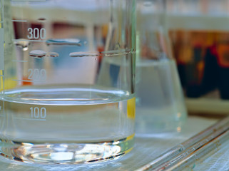 Laboratory flasks and analysis tools. Against the background of blood tests. Macro. Closeup.