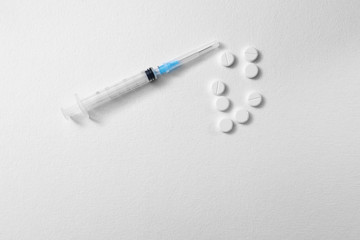 Pills and syringe isolated on white background. coronavirus, covid-19. Copy space