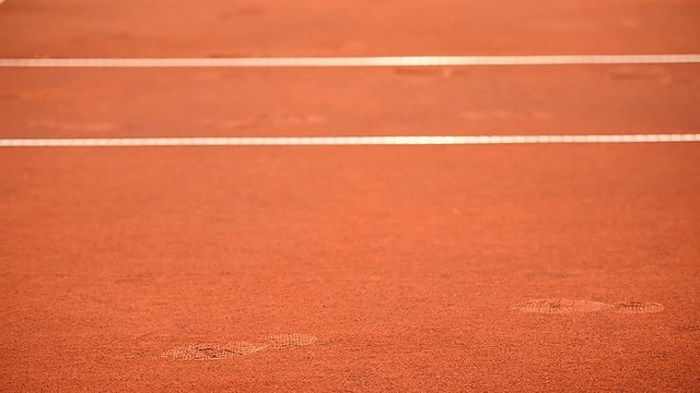 Detail with sport shoe footprint on a tennis clay court during a match