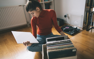 Young woman enjoy her vinyl record collection