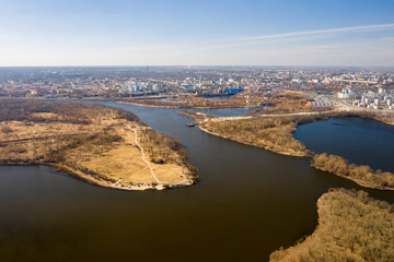 Aerial shot of the city of Gomel and the Sozh River in early spring. 17 microdistrict and Volotova. Sozh River and lakes. View of Gomel from a height. Beautiful landscape. Aerial view of the city.