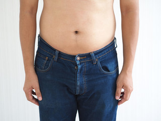 Naklejka premium belly fat in a man and the photo is used for liposuction concepts.