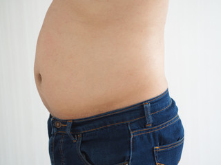 Naklejka premium belly fat in a man and the photo is used for liposuction concepts.