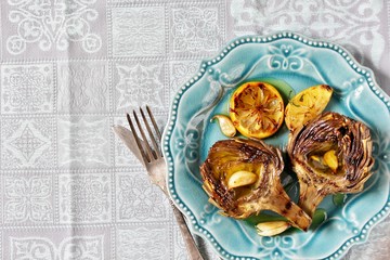 artichoke  grill. Tasty vegetables are first cooked for a couple, then fried on a grill, poured with olive oil and spices. Flatlay.  copy space. top view
