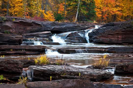 Glowing autumn colors at Bonanza Falls on the Big Iron River, Upper Peninsula, Michigan.