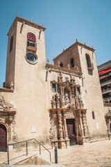 Fototapeta na wymiar Facade of Basilica of Santa Maria (Iglesia Fortificada de Santa María) with its Glorious Portal Door Gate, Alicante