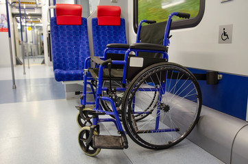 Empty wheelchair in an empty train car. Special express train for wheelchair disable person. Train for disabled people.