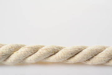White jute rope horizontal view. Piece of ship rope, close-up on white background.