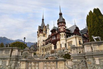 Fototapeta na wymiar Famous Peles Castle and ornamental garden in Romania, landmark of Carpathian Mountains in Europe