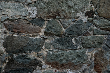 Texture of stone wall made of grey stones