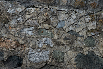 Texture of stone wall made of grey stones