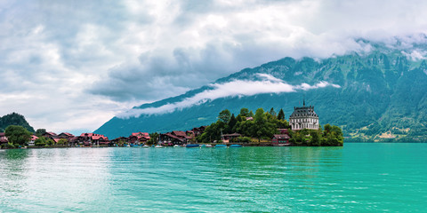 Panoramic view of the peninsula and former castle and Lake Brienz in swiss village Iseltwald, Switzerland
