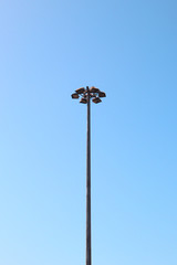 strong light post for sport statium on clear blue sky