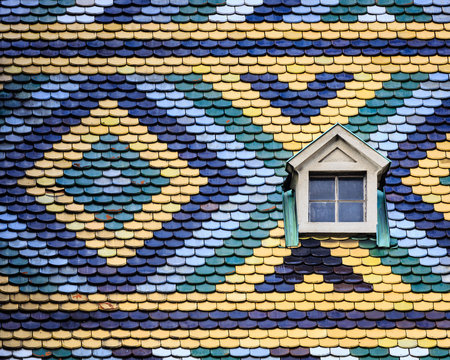 Geometric colorful roof of a house in Vienna with a single window