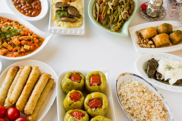 Setting table (Bayram sofrasi) with traditional Turkish foods for Sugar Feast after Ramadan Eve or Feast of Sacrifice..Copy space on middle of table . 	