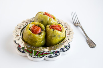 Traditional Turkish Rice Stuffed Green Bell Pepper,vegetarian food in the vintage silver bowl on the ceramic pad.Cooked with oil of olive.