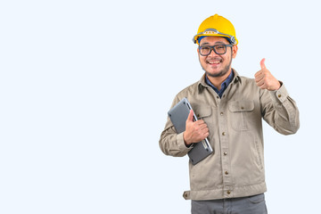 Young computer engineer asian man with laptop and yellow hard hat , Asian man point on empty space