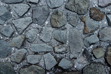 Texture of stone wall made of grey stones