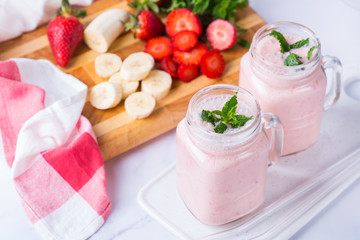 Pink smoothie with banana and strawberry for healthy, vegan diet